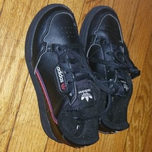 Kids Black Adidas with hints of red.